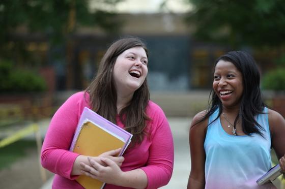 Photo of two young women walking on Shadyside Campus, smiling and talking