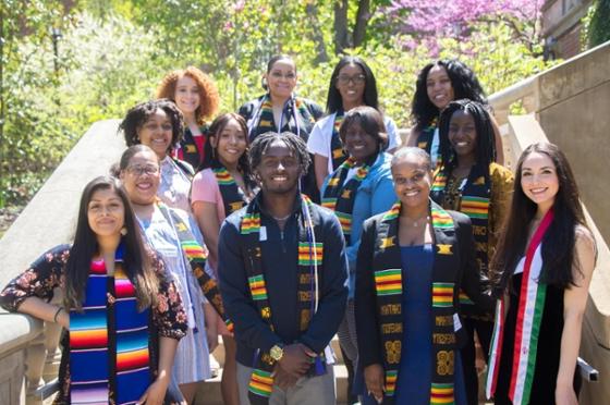 Photo of a group of students at Multicultural Graduation, wearing colorful graduation attire 